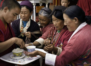 Gläubige nehmen gesegnetes Essen im alten buddhistischen Kloster - Foto von Daniel J Rao