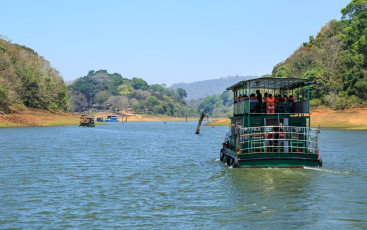 Touristen unternehmen eine Bootsfahrt auf dem Thekkady-See im Periyar-Nationalpark. Der Park bietet auch einen Zufluchtsort für Elefanten und Tiger. Zudem findet sich hier ein Modell für Stammesgemeinschaften, die in Harmonie mit dem Wald leben.